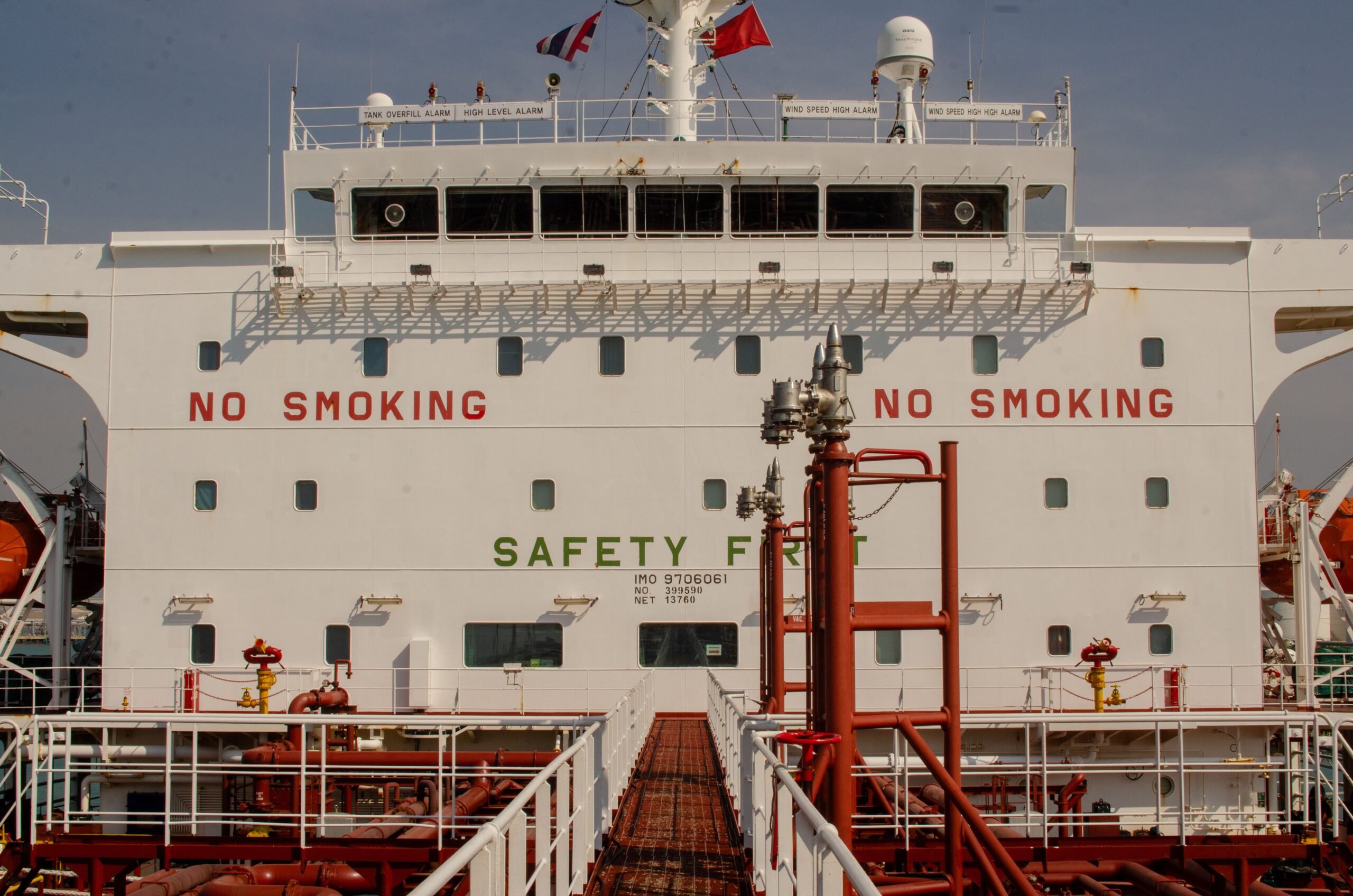 Close-up of a cargo ship with 'No Smoking' signs visible in the port.